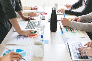 hands-on-desk-at-meeting-scaled